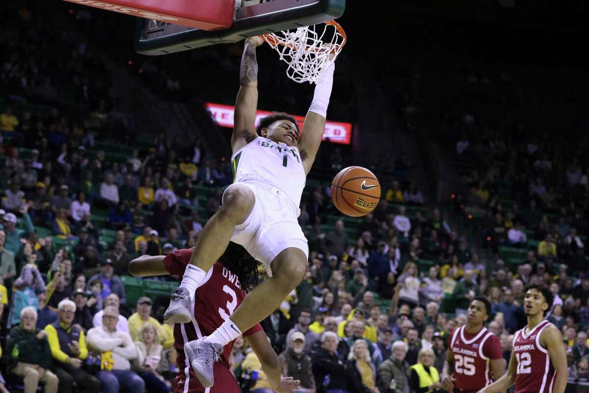 Baylor guard Keyonte George (1) dunks over Oklahoma guard Otega Oweh (3) during the first half of an NCAA college basketball game Wednesday, Feb. 8, 2023, in Waco, Texas.