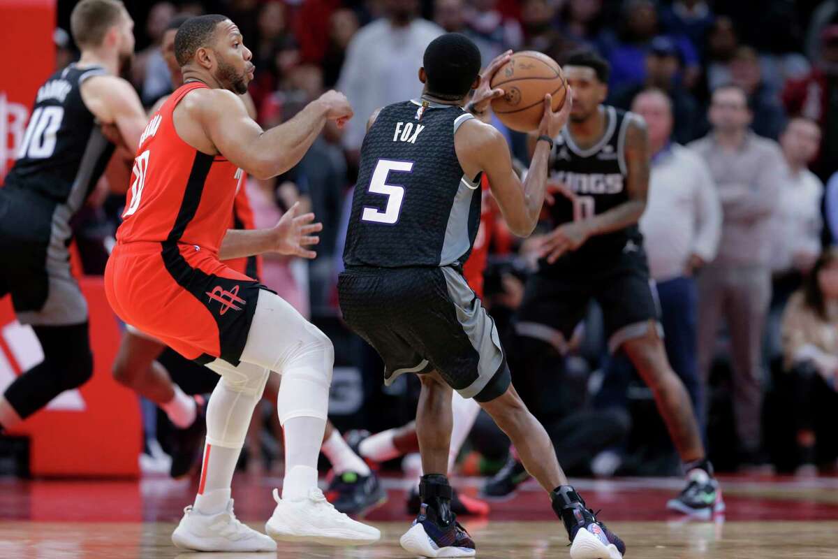 Sacramento Kings guard De'Aaron Fox (5) lines up for a 3-point shot as Houston Rockets guard Eric Gordon, left, moves in to defend, leading to a foul call on Gordon in the final second of an NBA basketball game Wednesday, Feb. 8, 2023, in Houston. The foul was upheld on a video challenge, and Fox made all three of his free throws. (AP Photo/Michael Wyke)