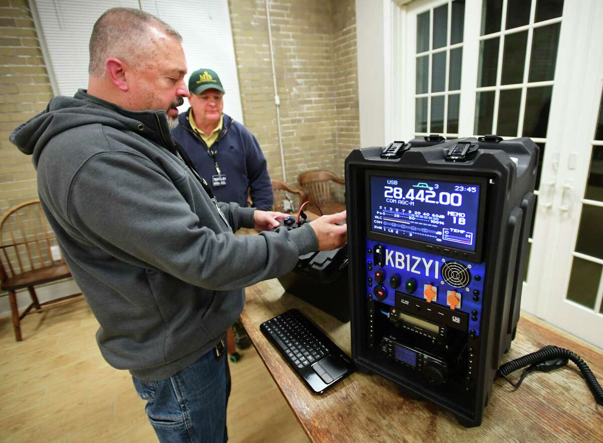 The Woodmont Amateur Radio Association club member Ralph Krohne, left, shows his go box portable ham radio set up to club president Ed Rhodes during the group's monthly meeting at the Woodmont Borough Hall in Milford, Conn. on Wednesday, Feb. 8, 2023.