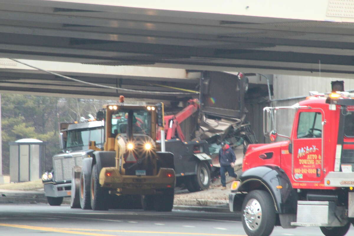A truck was left hanging from the Interstate 91 overpass on Poquonock Avenue in Windsor Thursday morning following a serious crash. State police said there were injuries reported.