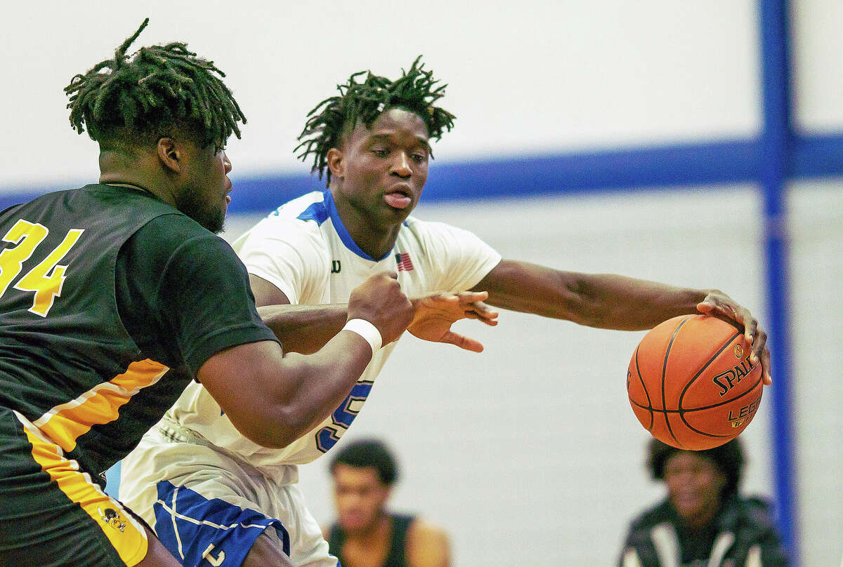 Lewis and Clark forward Souleymane Diaby, right, looks for room around Three Rivers' Hosana Kitenge Wednesday night at the River Bend Arena.