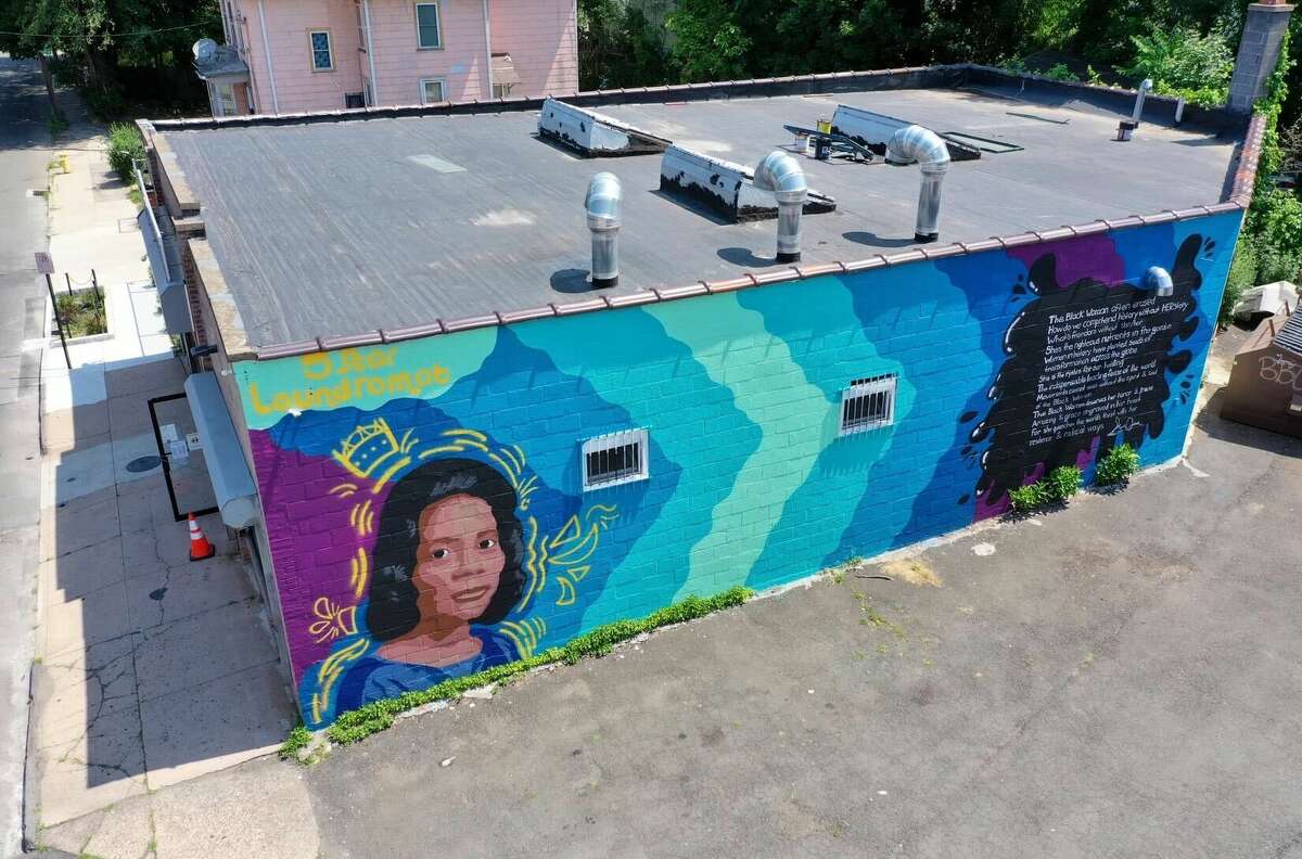 The MLK39 mural at the Five Star Laundromat Center in New Haven features Coretta Scott King and a poem by New Haven writer Sun Queen