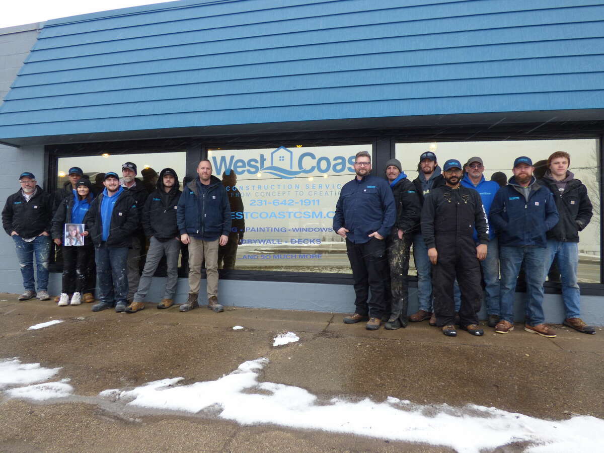 The West Coast Construction Services team stands in front of their building at 64 Arthur St. in Manistee.