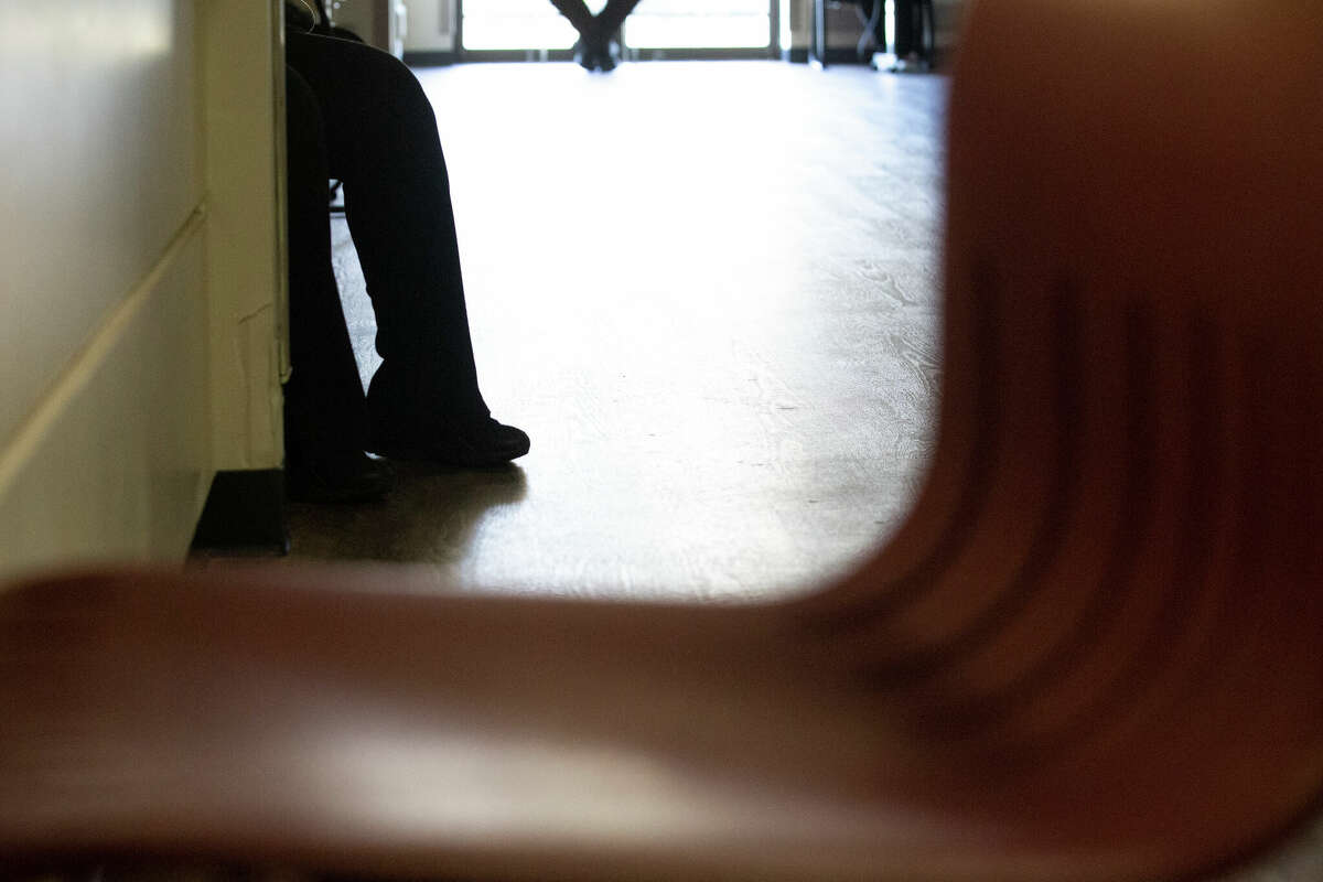 Harris County Mental Health Diversion Center Jail Diversion program patients sit in the hallway Monday, Dec. 21, 2020, in Houston. The Respite, Rehabilitation, and Re-Entry Center houses the Jail Diversion program. The diversion center diverted 3,069 people with mental illnesses from jail over two years.