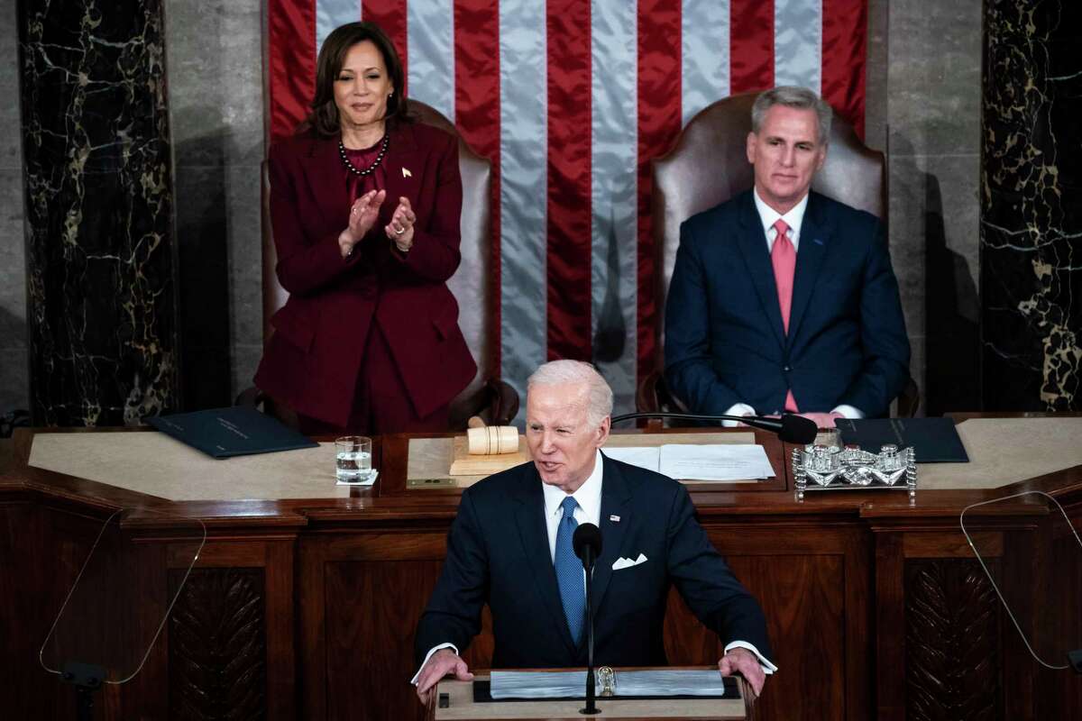 Vice President Harris, left and Speaker of the House Kevin McCarthy (R-Calif.), right, watch as President Biden delivers his State of the Union address Feb. 7 to a joint session of Congress on Capitol Hill in Washington. (