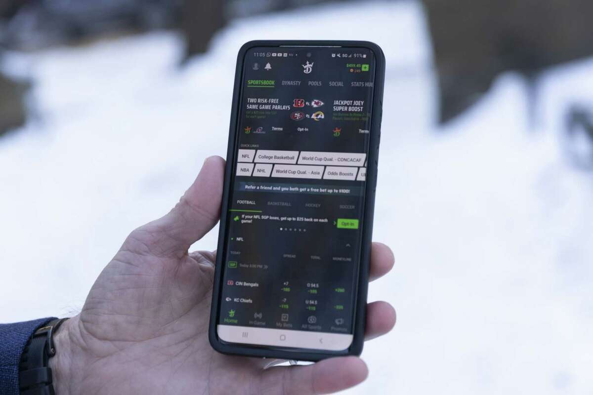The DraftKings application on a smartphone arranged in New York, U.S., on Sunday, Jan. 30, 2022. More than 1.1 million accounts were created in New York in the first two weeks of legalization, according to GeoComply Solutions Inc., which monitors transactions.