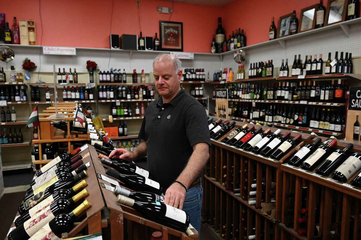 Colvin Wine Merchants owner Stefan Kalogridis works in his store on Thursday, Feb. 9, 2023, at Colvin Wine Merchants in Albany, N.Y. Kalogridis is president of the New York State Liquor Store Association, who have concerns about costs and implementation of proposed state legislation to expand the current bottle bill laws. The enhanced bill would also raise the cost of a deposit from 5 to 10 cents.