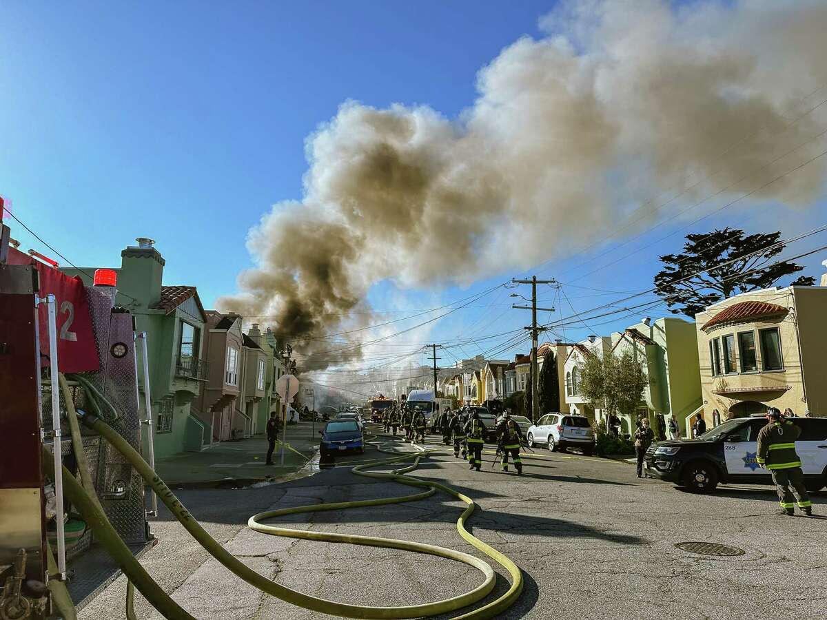 San Francisco Fire Department rush on scene of the fire that broke out on 22nd Avenue in the Sunset District.