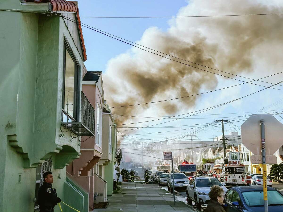 San Francisco firefighters rush to the scene of the fire that broke out in a home in the Sunset District of San Francisco last Thursday.