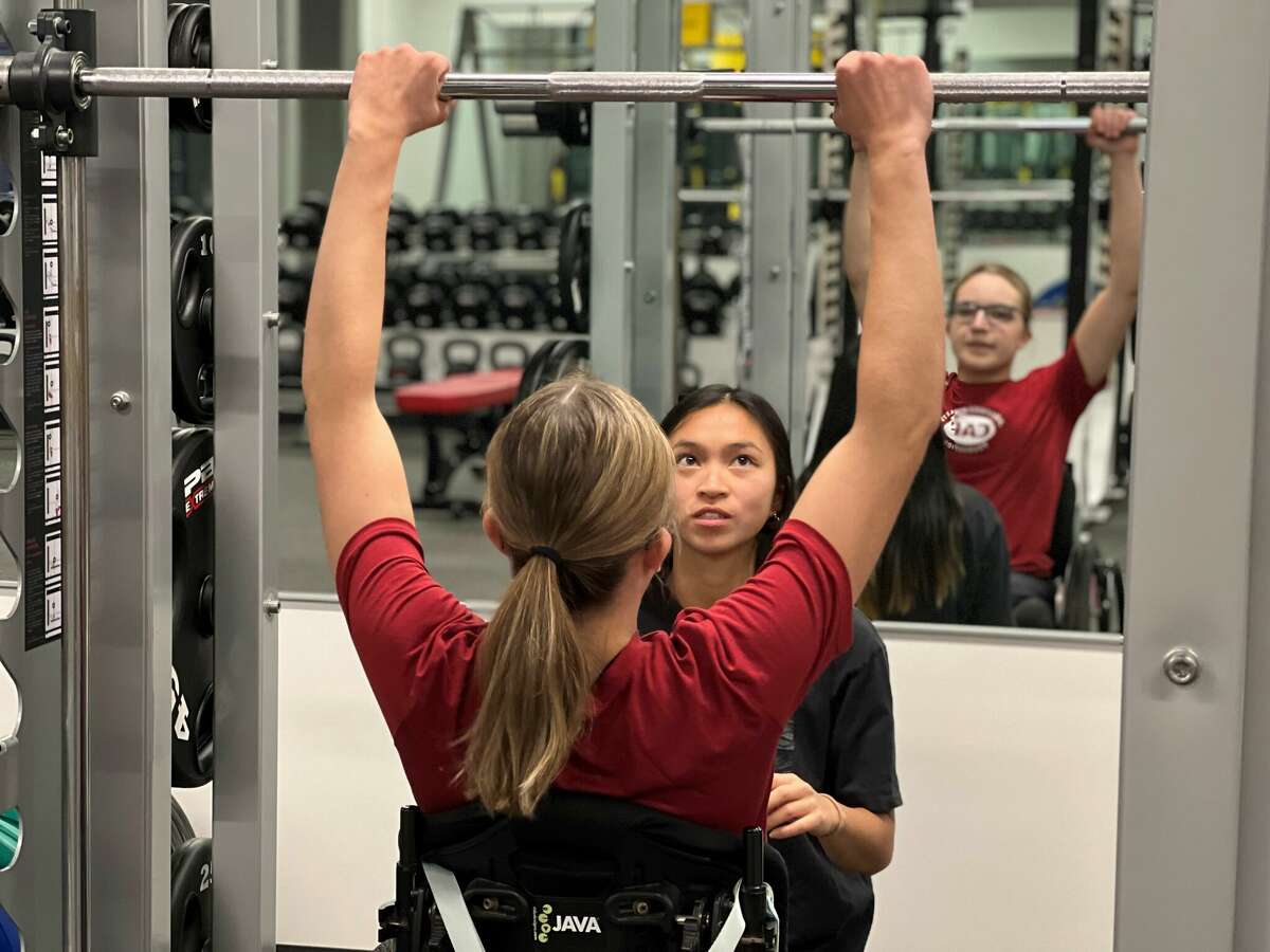 A University of Hartford student works with a participant during a previous "Hawks in Motion" exercise program that offers free physical therapy to people with neurodevelopmental disabilities.