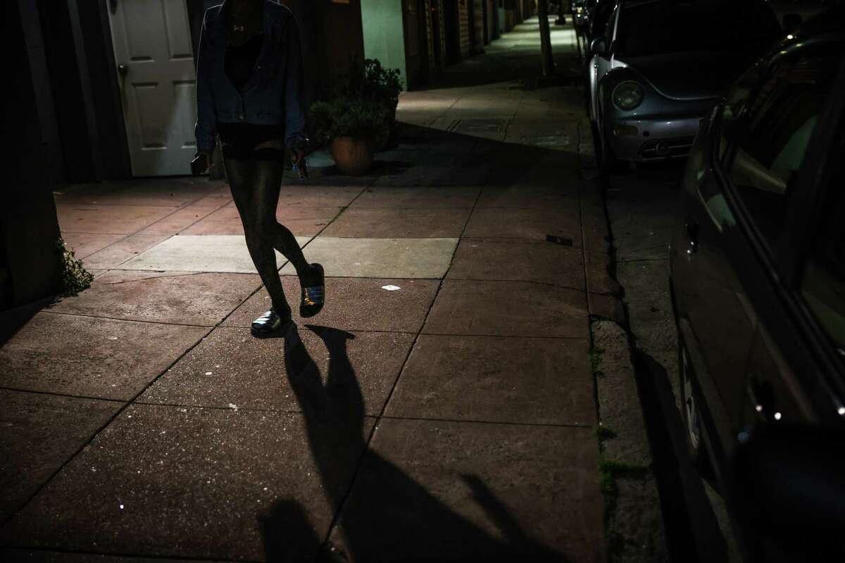 A sex worker named Nyomie walks down Capp Street on Wednesday.