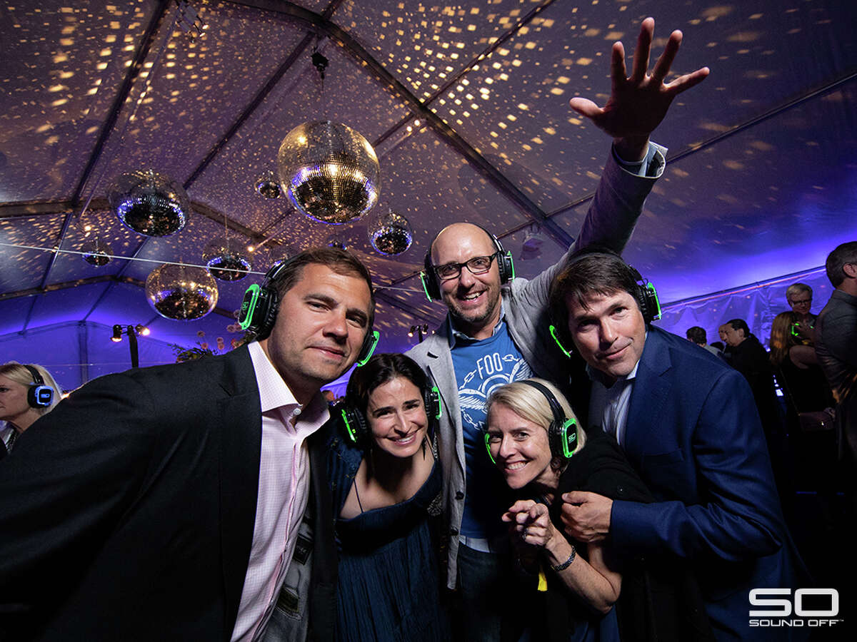 Attendees pose at a silent disco, in a photo provided by Sound Off, a company that specializes in wireless headphone events.  