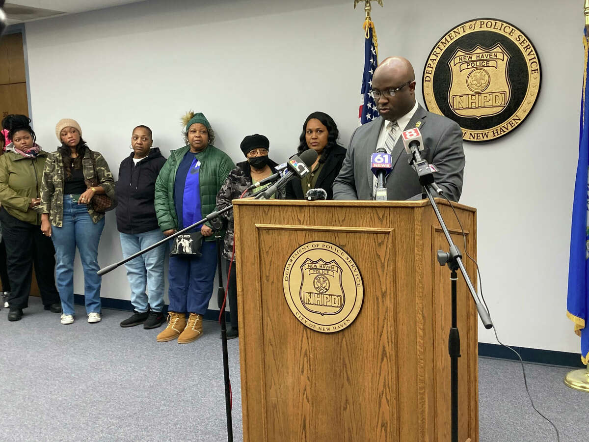 New Haven Police Assistant Chief Bertram Ettienne speaks during a Thursday news conference while family members of Michael Wint, fatally shot Jan. 21, stand in the background.