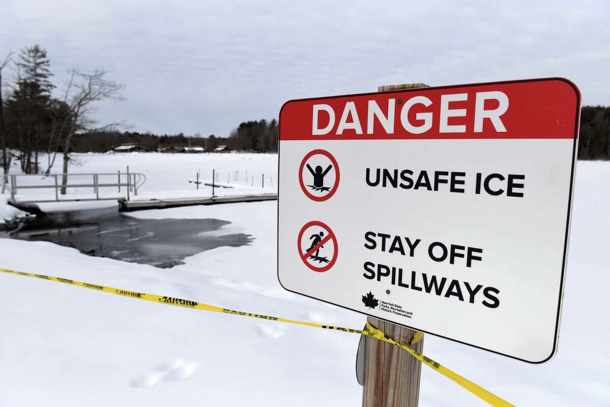 Warning signs are posted around the spillways on Long Pond where the ice is thin on Thursday, Feb. 2, 2023, at Grafton Lakes State Park in Grafton, N.Y.
