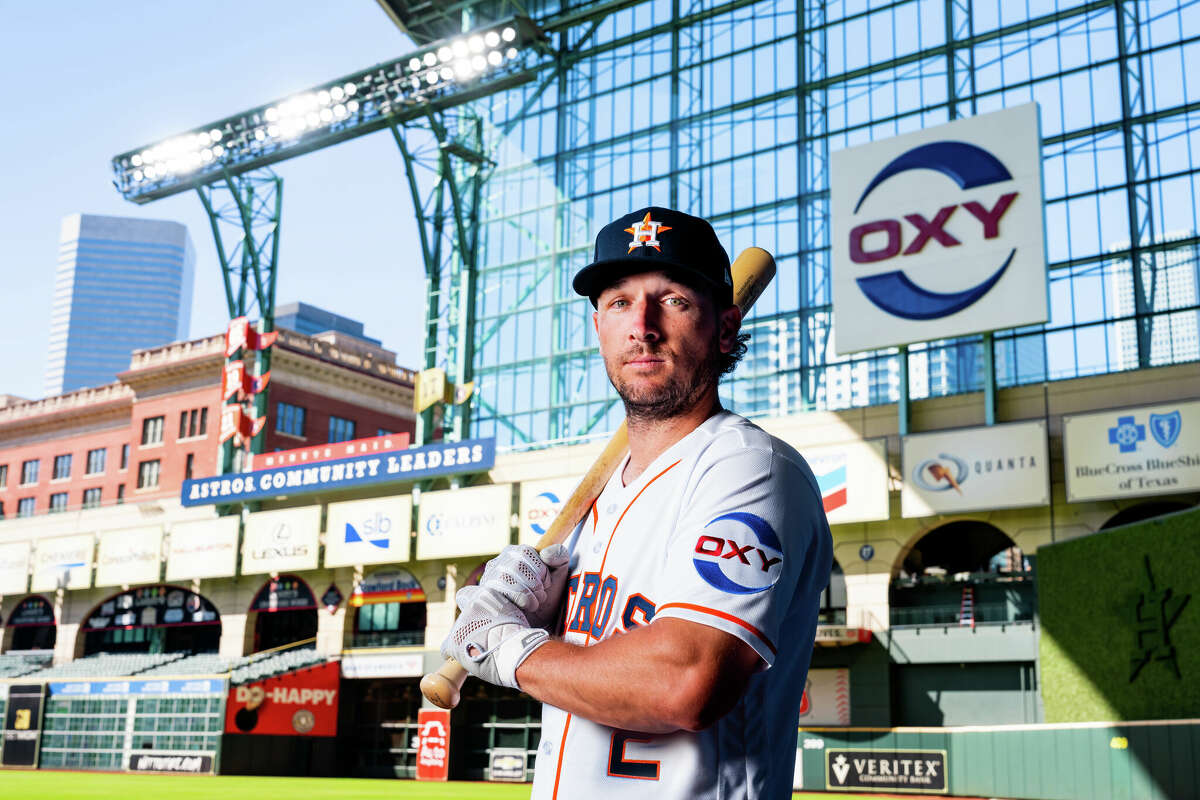 Alex Bregman shows off the Oxy patch that will be on the team's jerseys in the 2023 season. 