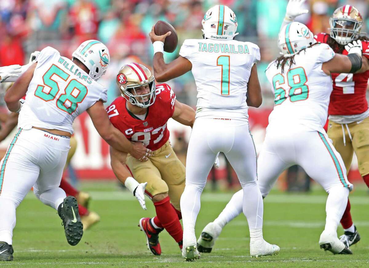 The Niners' Nick Bosa homes in on Dolphins quarterback Tua Tagovailoa during a game in December.