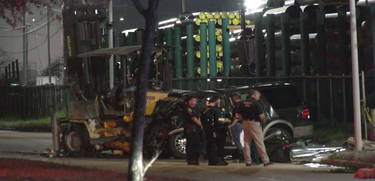 Investigators at a crash scene on Bellfort in south Houston, Feb. 9, 2023.
