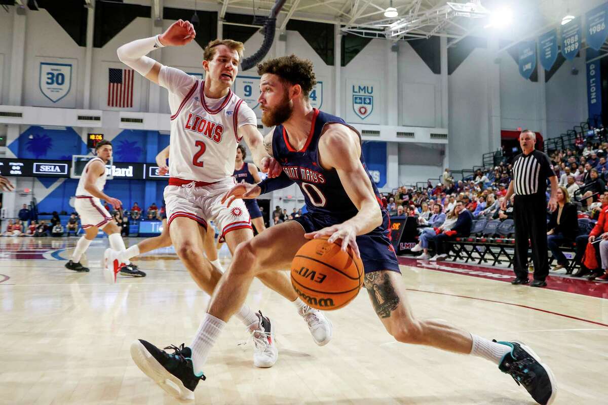 Saint Mary's guard Logan Johnson, right, drives past Loyola Marymount guard Justin Ahrens during the first half of an NCAA college basketball game Thursday, Feb. 9, 2023, in Los Angeles. (AP Photo/Ringo H.W. Chiu)