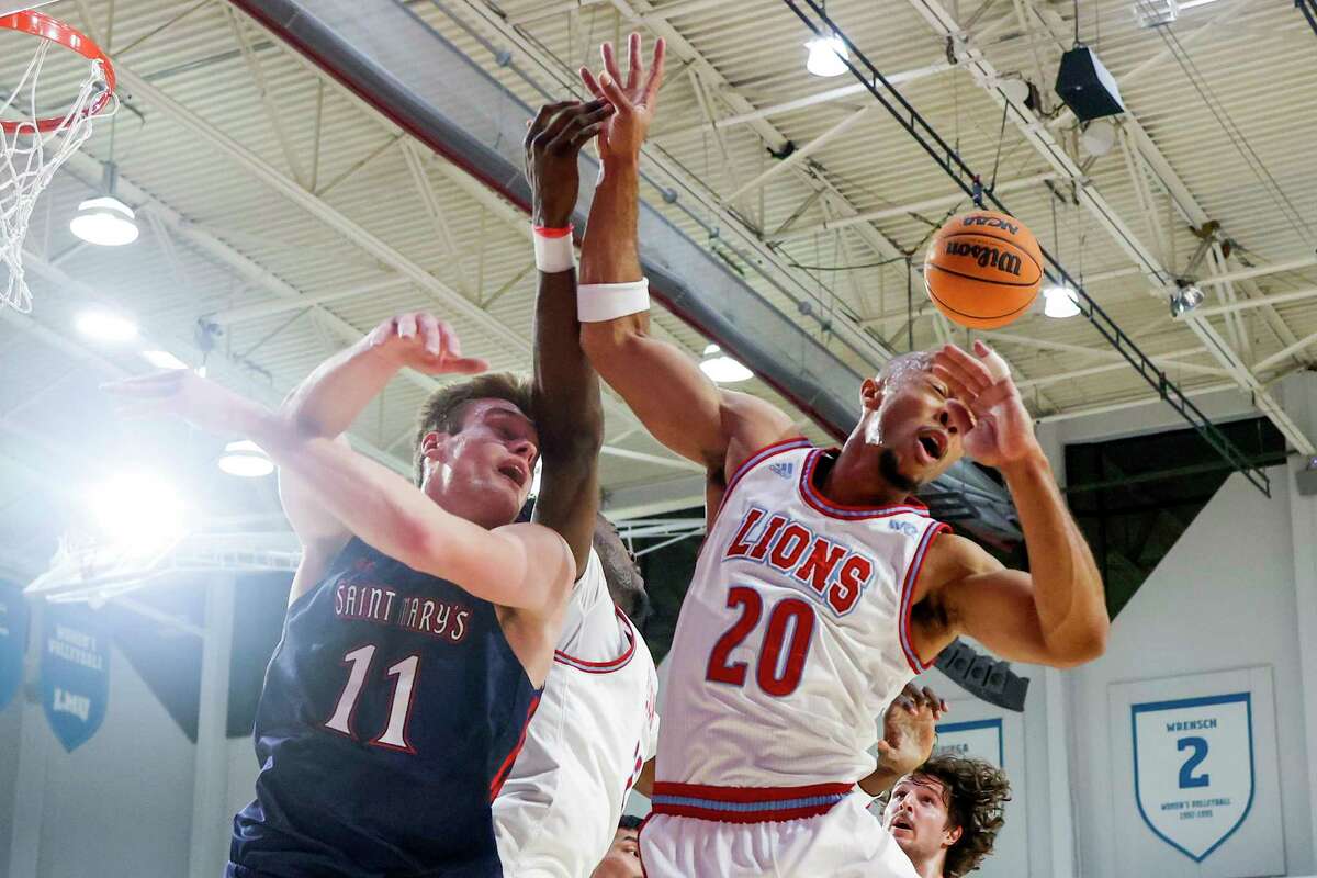Saint Mary's center Mitchell Saxen, left, and Loyola Marymount guard Cam Shelton (20) fight for the rebound during the first half of an NCAA college basketball game Thursday, Feb. 9, 2023, in Los Angeles. (AP Photo/Ringo H.W. Chiu)