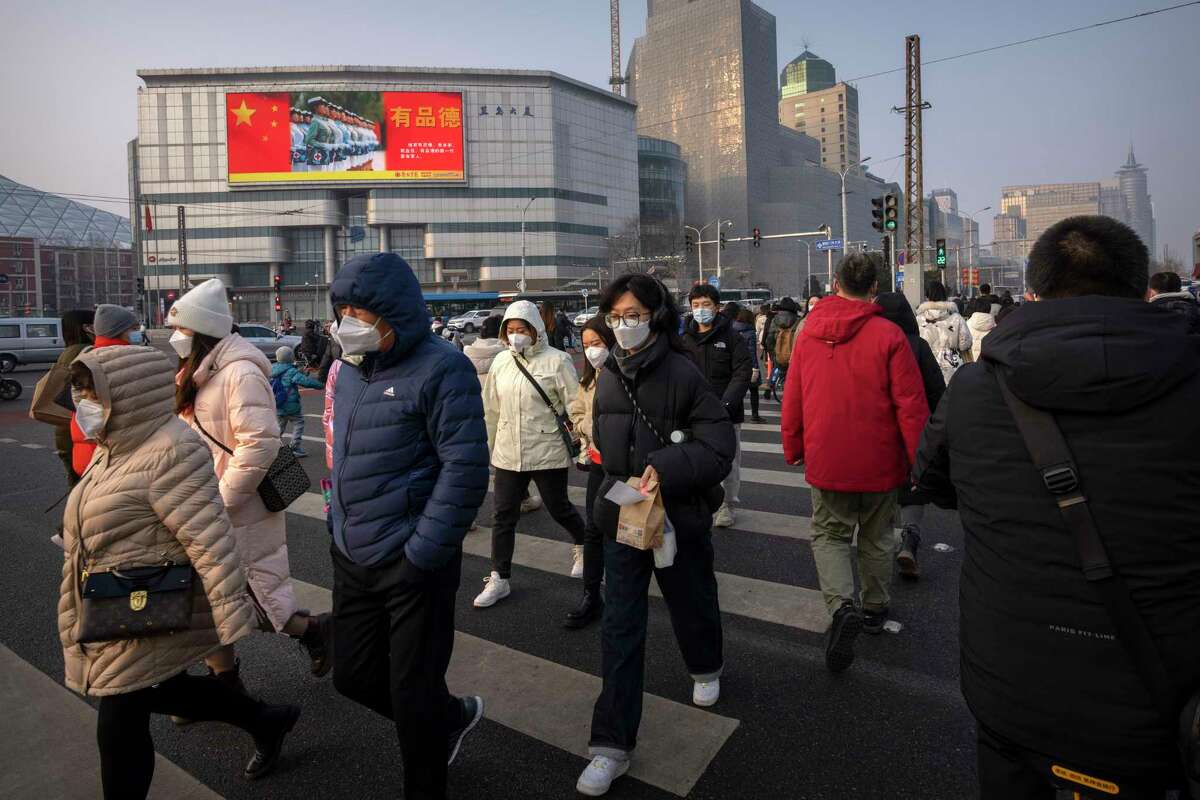 Commuters wearing face masks during the morning rush hour in Beijing. The country's steep reported drop in its death counts from COVID is raising questions anew about the accuracy of its data.