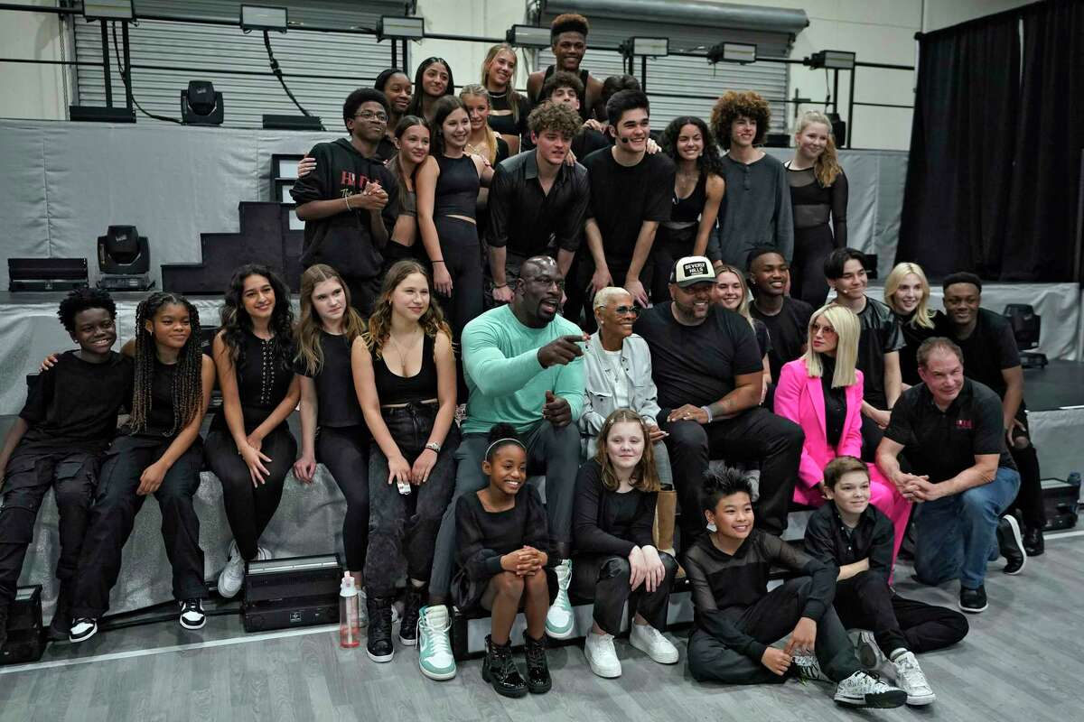 Cast and crew members pose for a photo during a rehearsal for the touring show "Hits! The Musical" Wednesday, Feb. 8, 2023, in Clearwater, Fla. Singer Dionne Warwick and her son Damon Elliott are co-producing the 50-city touring show.