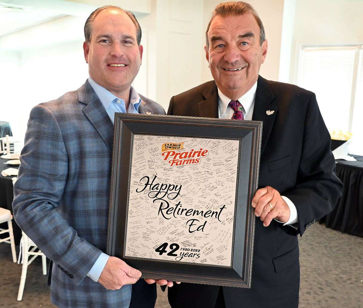 Current CEO for Prairie Farms Matt McClelland, left, presents former CEO Ed Mullins with a retirement gift during a recent event at Prairie Farms' headquarters in Edwardsville.