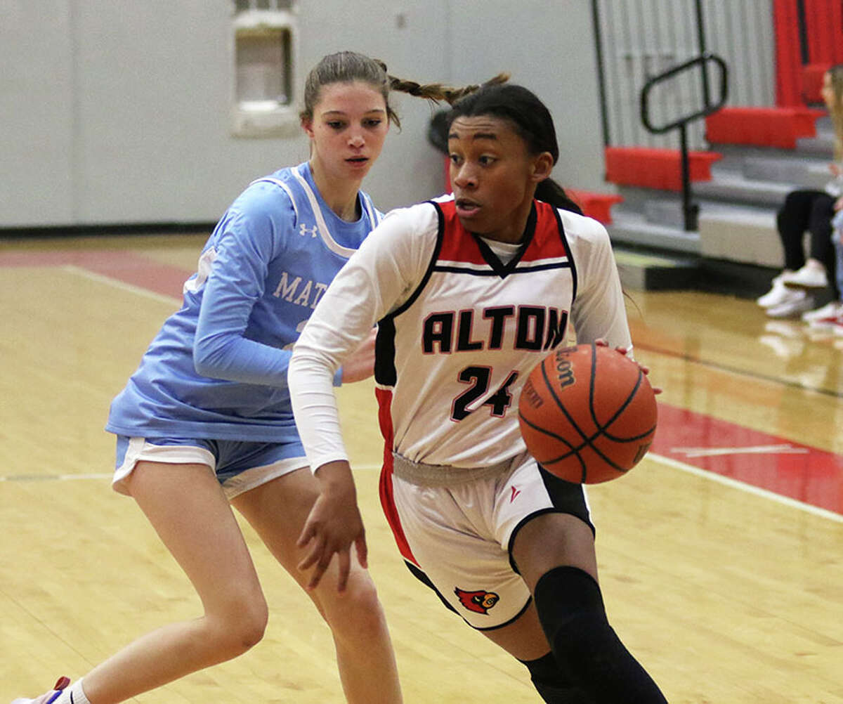 Alton senior Laila Blakeny (right) takes the ball to the baskett past a Breese Mater Dei defender in a November game at Alton High in Godfrey. On Thursday, Blakeny scored a career-high 30 points in a Senior Night win at home over Collinsville.