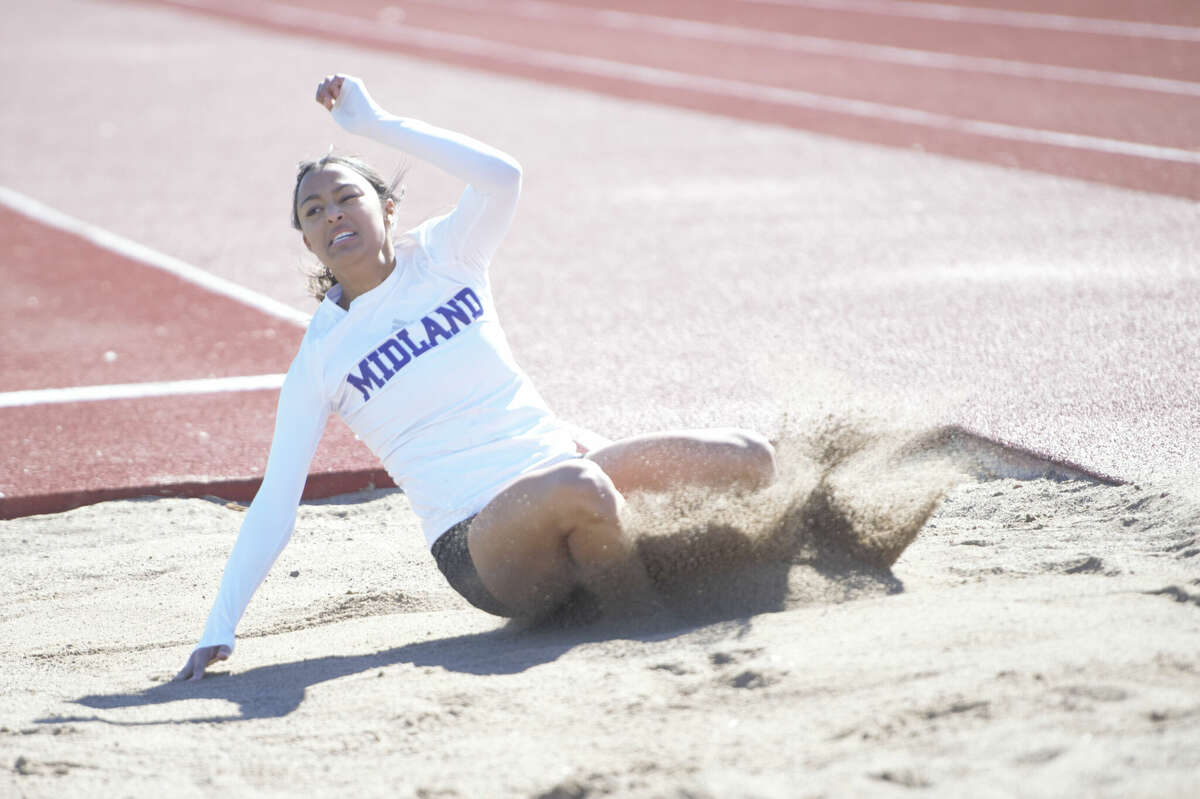 Midland High senior Brielle Bracken lands in the sand pit during the girls long jump at the Tall City Relays track & field meet, Feb. 10 at Memorial Stadium. 
