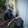 Henry Mechanical employee Jose Martinez installs a heat pump at a home in Windsor, Calif. on Friday, Feb. 10, 2023. The Bay Area Air Quality Management District has proposed requiring all new construction to use electric water heaters by 2027 and heat pumps instead of furnaces by 2029.