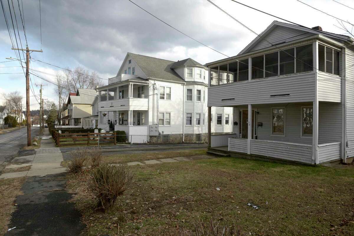 A multifamily house at 98 Elm St. in Danbury (right) would be demolished and a 3-story dormitory building in the back of the property owned by the city's housing authority would be bought by Danbury for use as a 20-bed shelter for the homeless under a complicated multi-party agreement the City Council must approve. 