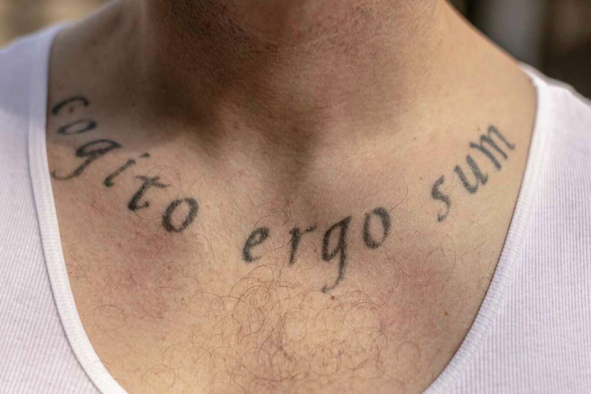 A tattoo is seen on Luke Scarmazzo, who was released on February 3 after serving 14 years of a 22-year federal sentence for operating a medical cannabis dispensary, in Modesto, California Friday, Feb. 10, 2023. The tattoo, the Latin phrase “Cogito Ergo Sum” that commonly translates as “I think, therefore I am,” was inked while he was incarcerated. A week since his compassionate release, Scarmazzo is slowly adjusting to life as a free man, including his first meal at a Pizza Hut, as well as picking up an iPhone 14 yesterday, 14 years since he got his last phone, the original first generation iPhone.