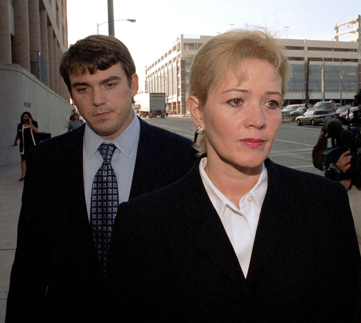 Dr. Clara Harris, right, accompanied by attorney Dee McWilliams, walks to the Harris County Criminal Justice Center on Friday, July 26, 2002. Harris was charged with murder, accused of running her husband over three times then leaving her silver Mercedes-Benz parked on top of him.