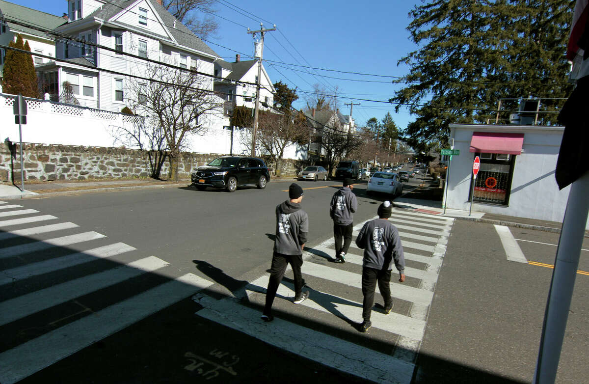 Pedestrians cross New Lebanon Ave along  Delavan Ave in Greenwich, Conn., on Friday February 10, 2023. The town is looking at putting new crosswalks across  Delavan Ave at the intersection with Chestnut and New Lebanon.