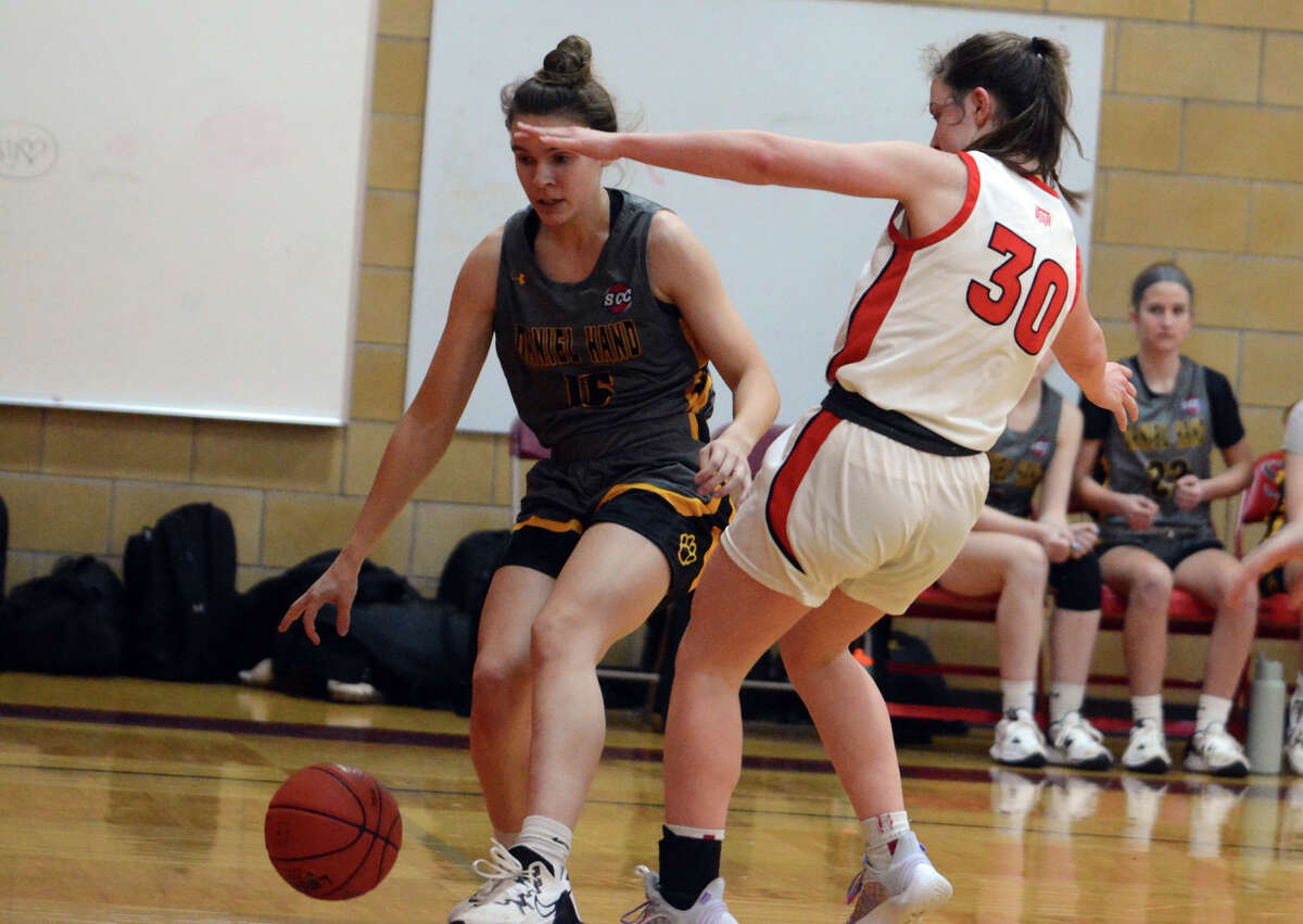 Annie Goodrich of Hand tries to dribble past Emmy Mennillo of Sacred Heart Academy.