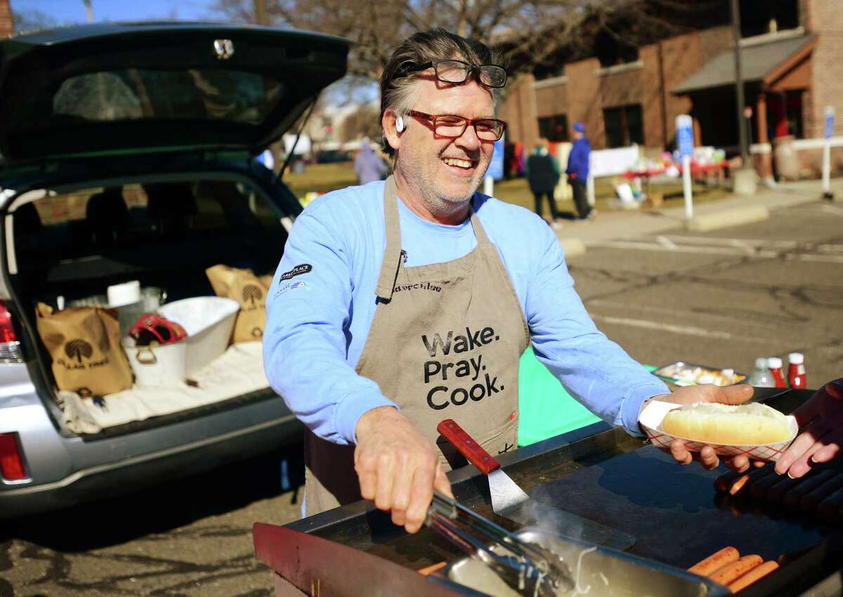 Mary Taylor Memorial United Methodist Church parishioner Barron Grasso, of Branford, cooks hot dogs at the Souper Bowl tailgating party to collect food and monetary donations for the Beth-El Center and Milford Food Bank in Milford, Conn. on Saturday, February 11, 2023.