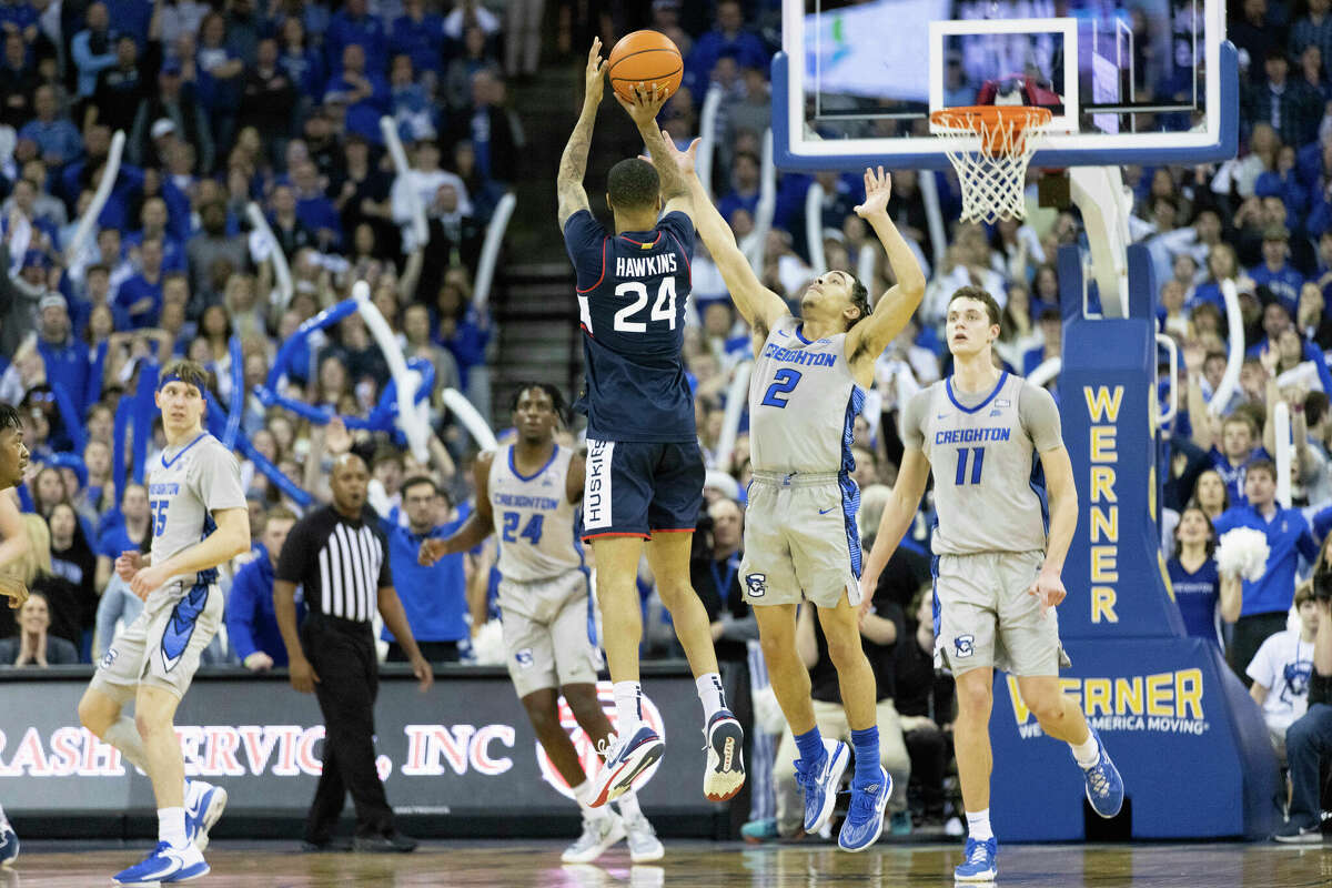 UConn's Jordan Hawkins (24) shoots against Creighton's Ryan Nembhard (2) during the second half of an NCAA college basketball game on Saturday, Feb. 11, 2023, in Omaha, Neb. Referees ruled it two-point shot since Hawkins' toe was just over the line. Creighton defeated UConn 56-53. (AP Photo/Rebecca S. Gratz)