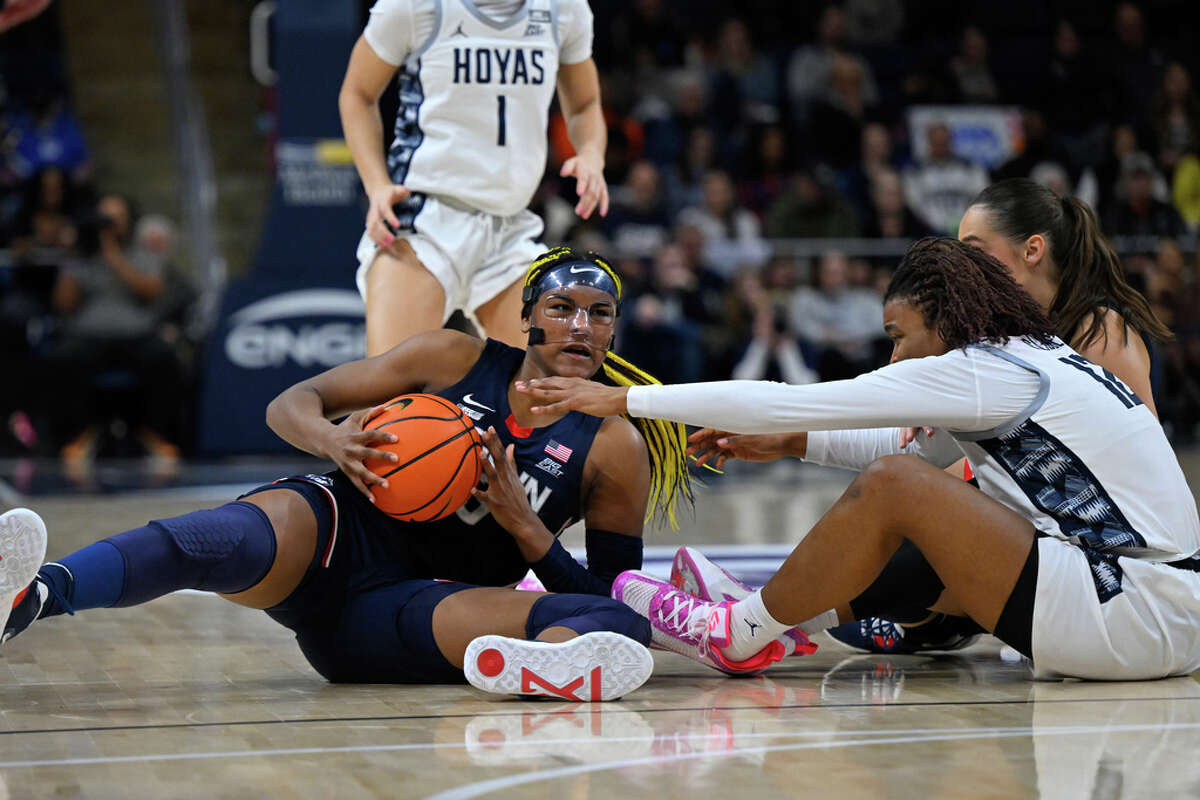 UConn forward Aaliyah Edwards, front left, grabs the ball from Georgetown forward Jada Claude, front right, during the second half of an NCAA college basketball game, Saturday, Feb. 11, 2023, in Washington. (AP Photo/Terrance Williams)