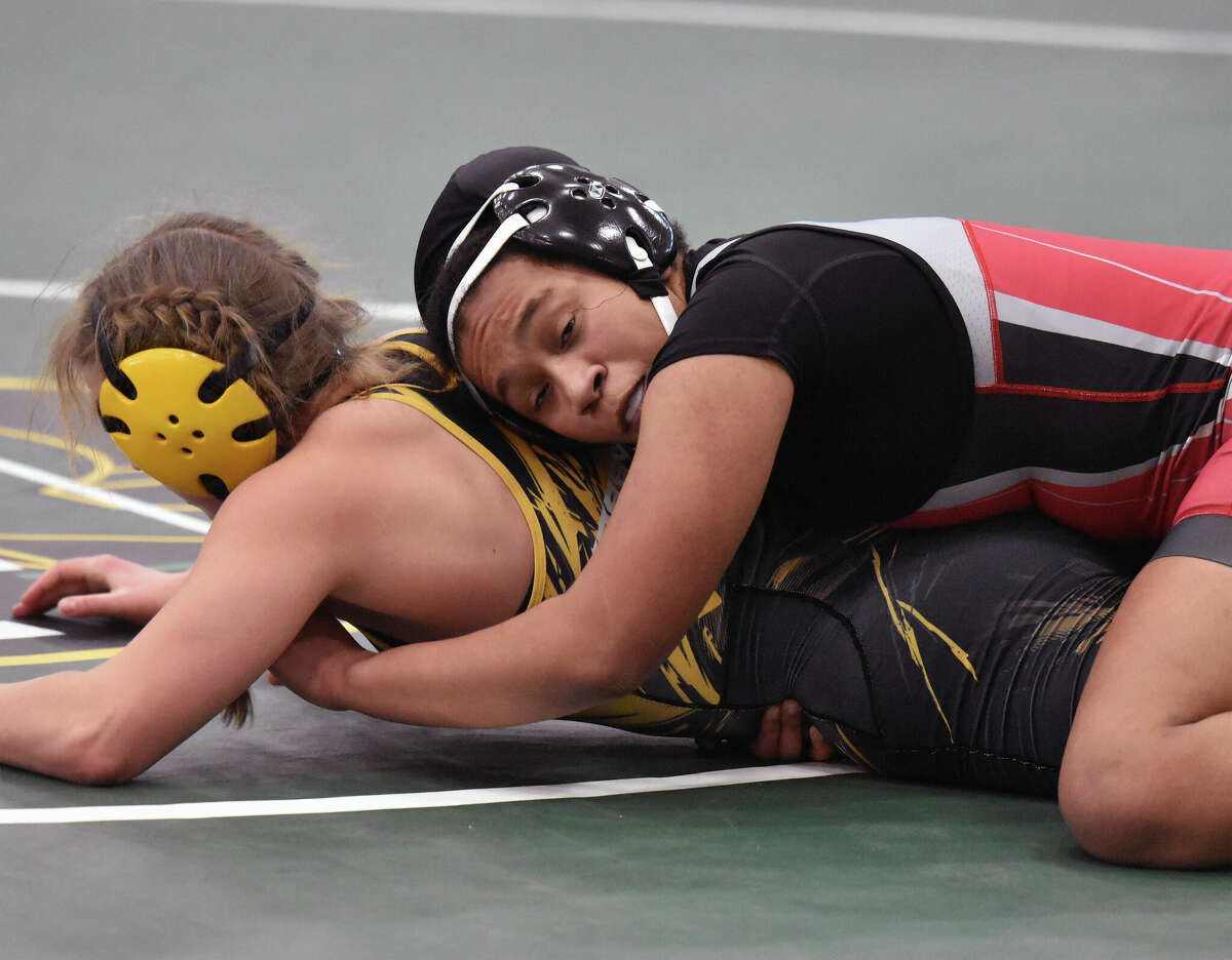 Alton High senior Antonia Phillips, right, won a pair of 145-pound matches by fall Friday at the IHSA Girls Individual State Wrestling Tournament in Bloomington and advanced to the state semifinals. Phillips is the defending 145-pound state champion.