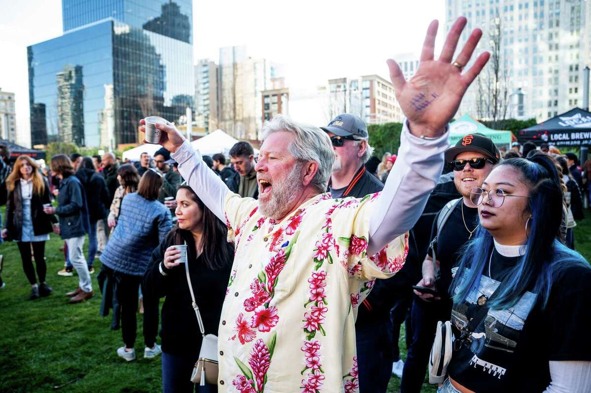 Tony Marotto cheers as the band Audiodub plays during the celebration of suds.