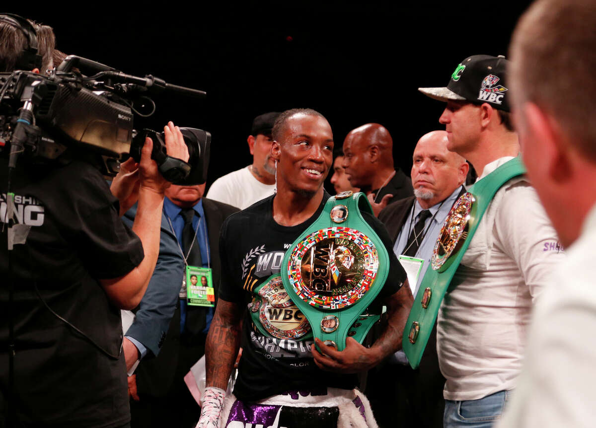 O'Shaquie Foster smiles at his trainer Bobby Benton (right) after defeating Rey Vargas in the WBC Super Featherweight World Championship at Alamodome on Feb. 11, 2023 in San Antonio.