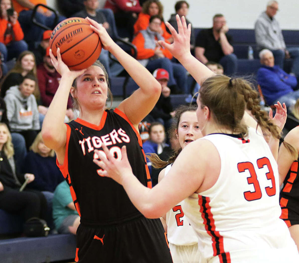 Greenfield's Kylie Kinser (left) shoots in a game at January's North Greene Tourney in White Hall. Kinser, a senior, and her Tigers teammates will be at home this week for the Greenfield Class 1A Regional.