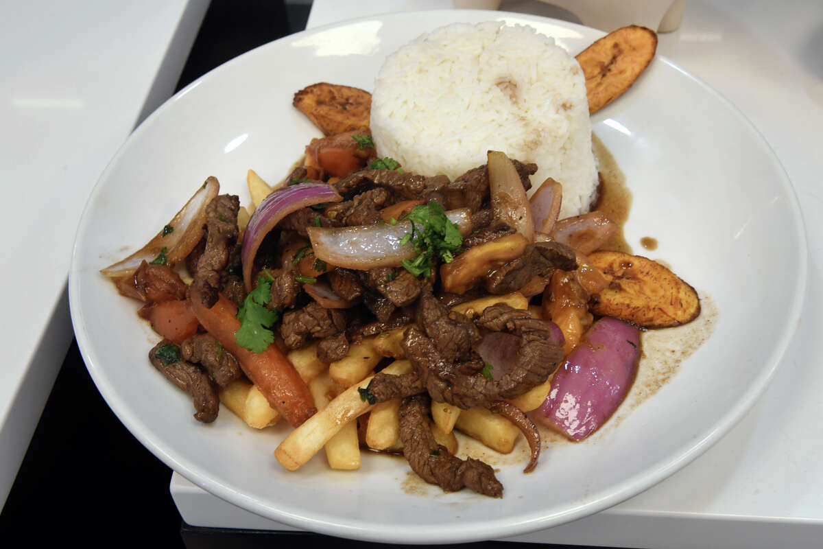 Grilled marinated steak served over french fried potatoes, plantains, rice and stir-fried vegetables, one of dozens of takeout options available at Lomito, a new Peruvian restaurant in Westport, Conn. Feb. 9, 2023.