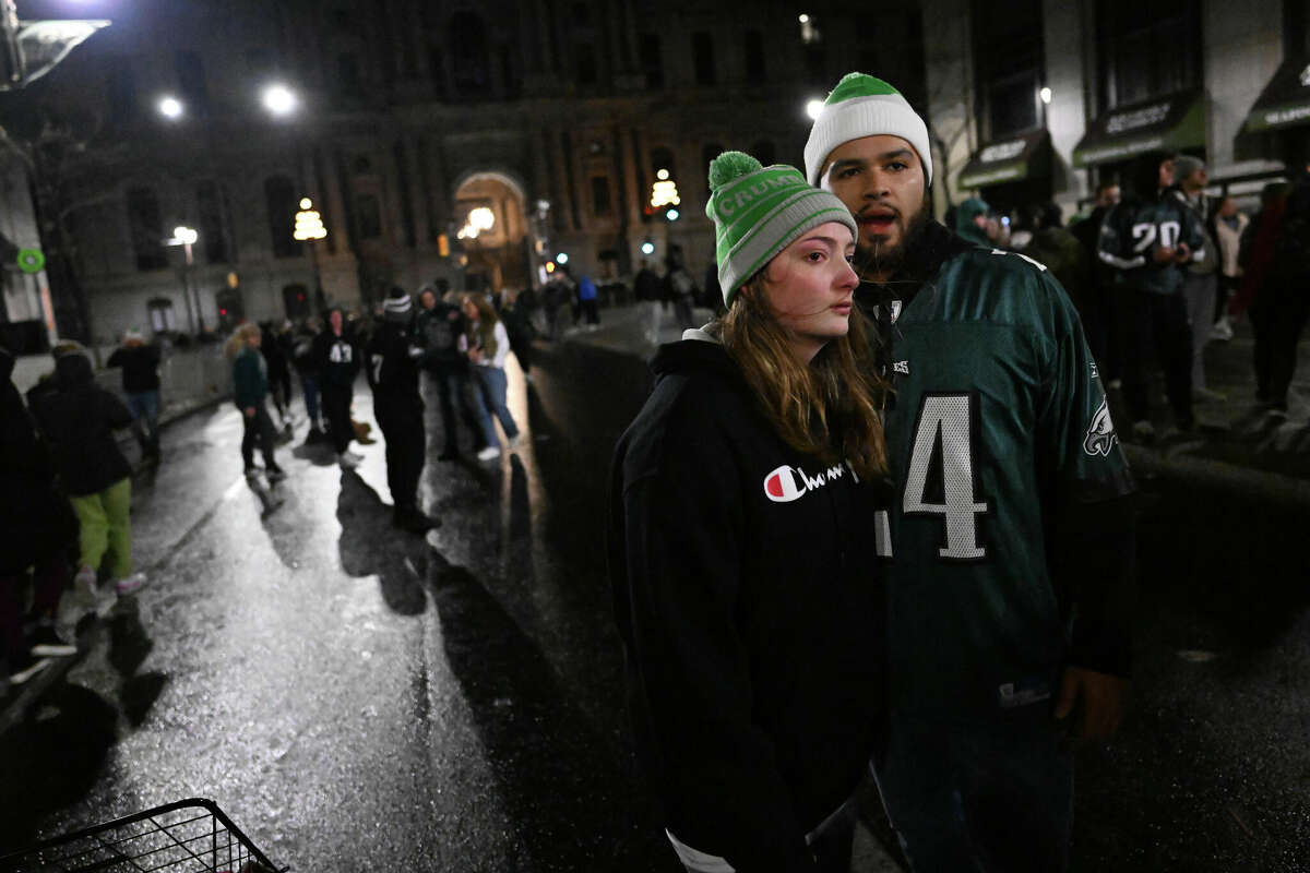A Philadelphia Eagles fan cries as they gather on Broad Street - not far from the Houston Rockets team hotel - after the Eagles lost the Super Bowl on Feb. 12, 2023 in Philadelphia, Pennsylvania.
