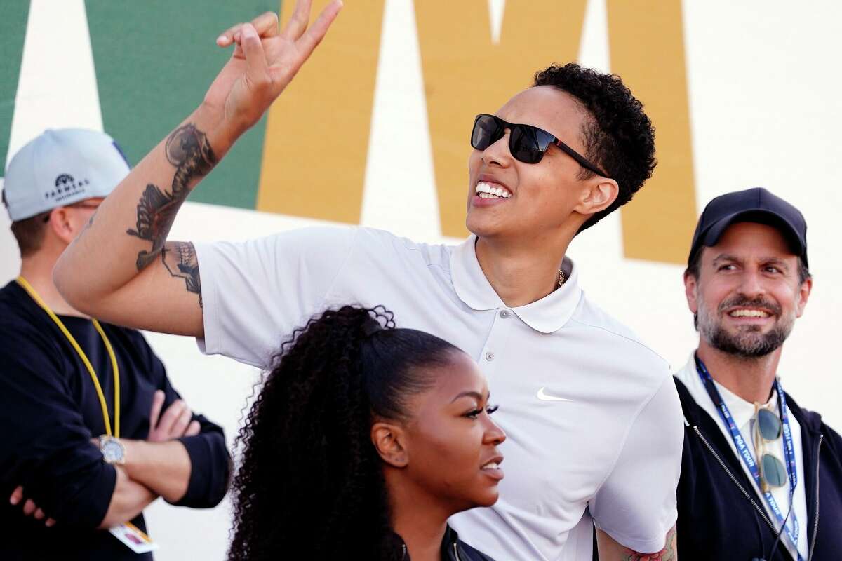 Brittney Griner acknowledges fans as she watches on the 16th hole during the third round of the Phoenix Open golf tournament, Saturday, Feb. 11, 2023, in Scottsdale, Ariz. (AP Photo/Darryl Webb)