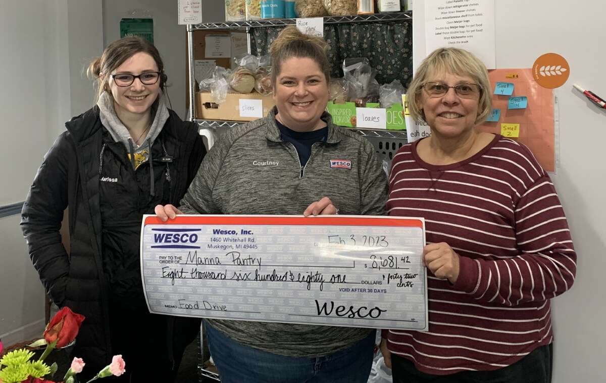 Manna Pantry director Bonnie Clark (right) receives a $8,641 donation check from WESCO manager Courtney DePew (center) and assistant manager Marissa Russell, who are all Part of the WESCO Round Up Program in which customers round up their purchase to donate to local food pantries.