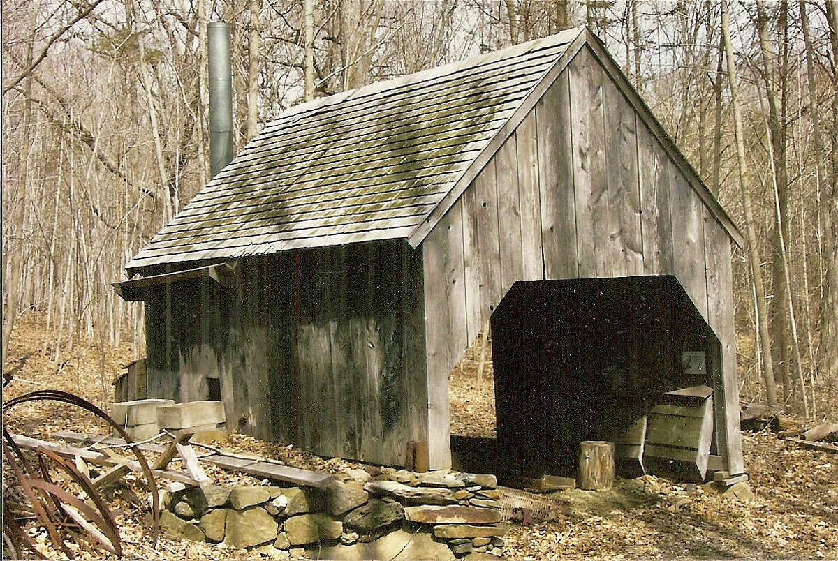 File photo: A reconstruction of the original sugar house at Dudley Farm where maple syrup is produced as it was on the farm in the late 19th century.