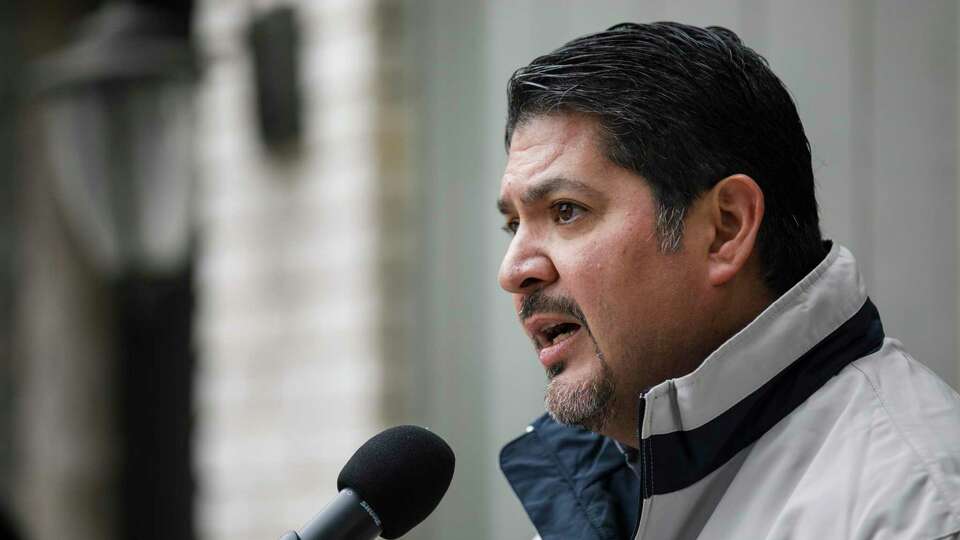 CPS Energy President and CEO Rudy Garza addresses a large crowd as they stand outside of Janie Garcia's home to celebrate CPS Energy's milestone of upgrading 30,000 homes through the utility's SaveNow Casa Verde Weatherization program in San Antonio, Texas, Friday, Feb. 10, 2023.