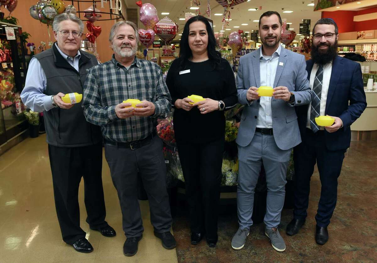 From left, Shoprite owner Harry Garafalo, Tim Brelsford, general manager of Alltown Fresh, Sahily Diezdeandino, universal banker at Liberty Bank, Tony Pereira, branch manager of Ion Bank, and Rabbi Moshe Hecht hold the ARKs, for the Acts of Random Kindness program inside Shoprite, one of the participating business, on Dixwell Avenue in Hamden Monday.