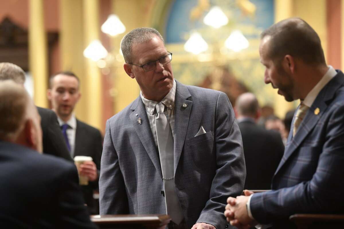Michigan District 97 State Representative Greg Alexander, (center) pictured here talking with Representative Matthew Bierlein called the updated House Bill 4001 a "Bait and Switch" after it was rushed through the House a second time.