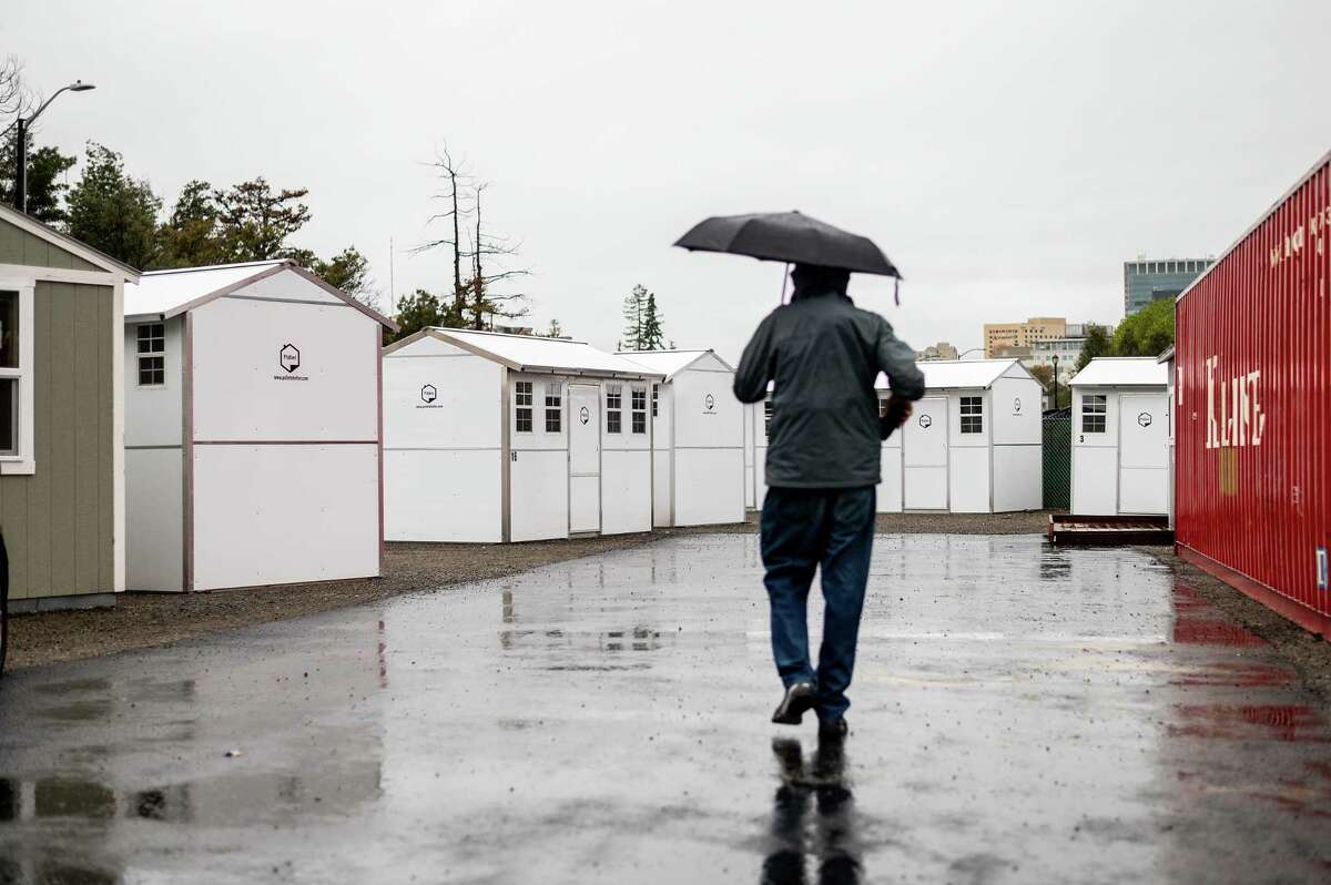 Tiny homes, which will shelter the homeless, line Lakeview Village in Oakland.